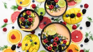 A colorful assortment of fresh fruit bowls featuring mixed berries and citrus slices, perfect for healthy eating inspiration.